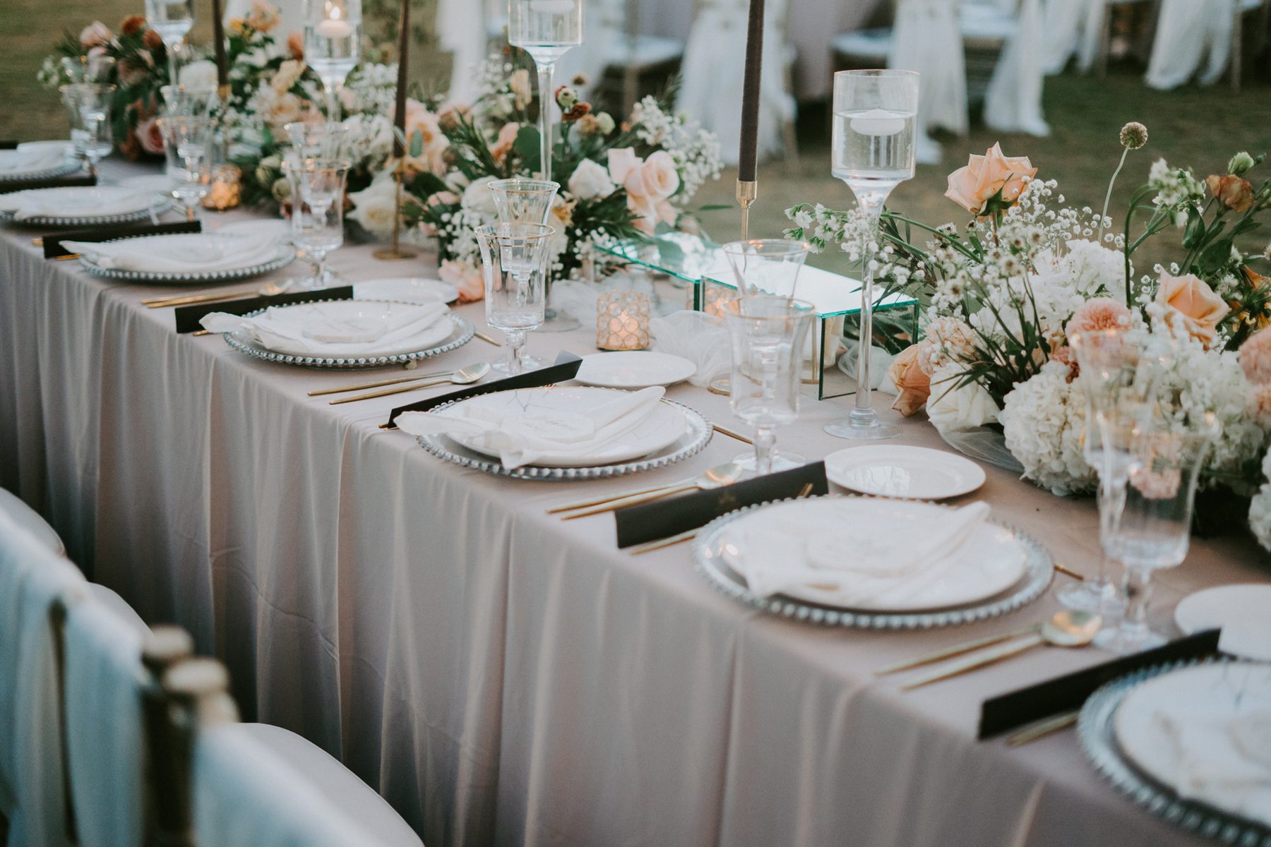 A blush and ivory tablescape set for dinner